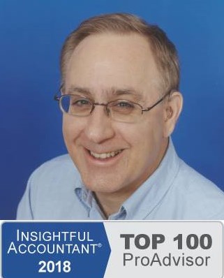 Photograph of Keith Gormezano, famous QuickBooks Trainer, Tutor, Instructor, Coach, or Teacher for new businesses and start ups in Seattle, Washington State who offers personalized, in person, one-on-one classes and training or clean up or set up assistance at your place, his, a coffee shop, library, or other place with WiFi, or online using the phone and/or Instant Messenging (IM) wearing a pale blue button down business formal Nordstrom's shirt made of soft 100% cotton, short slightly receding light brown hair with a touch of gray showing his wisdom, blue eyes, trendy horizontal glasses with Transitions� photochromic lenses and flexible titaniam frames from Greenwood Optical, two behind the ear (BTE) Cantu� 780D hearing aids from The Hear Center since replaced by two Phonak Savia Arts with Bluetooth receivers so he can use them with his new cell phone with the company's SmartLink bridge and directional microphone device in noisy settings, and his always present smile and patience.